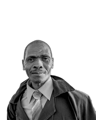 Portrait of a confident older man in a suit and tie, wearing a trench coat