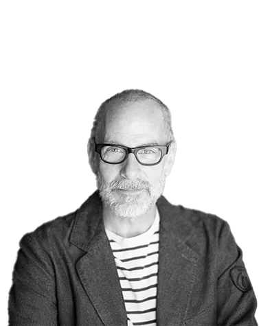 Portrait of a confident older man with glasses in a striped shirt