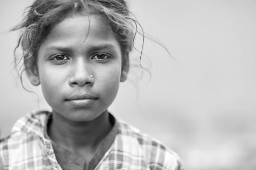 Portrait of a young girl looking at the camera, black and white photo
